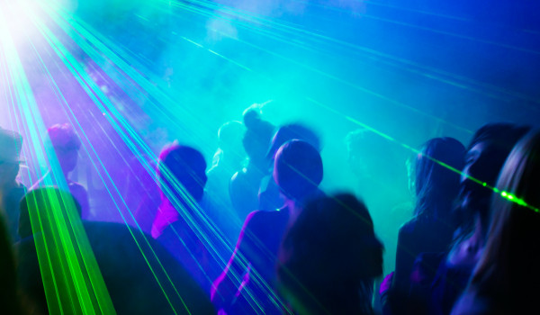 Party people dancing under laser light. Party people dancing under laser light.